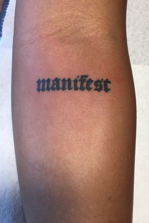 Manifest lettering tattoo. 