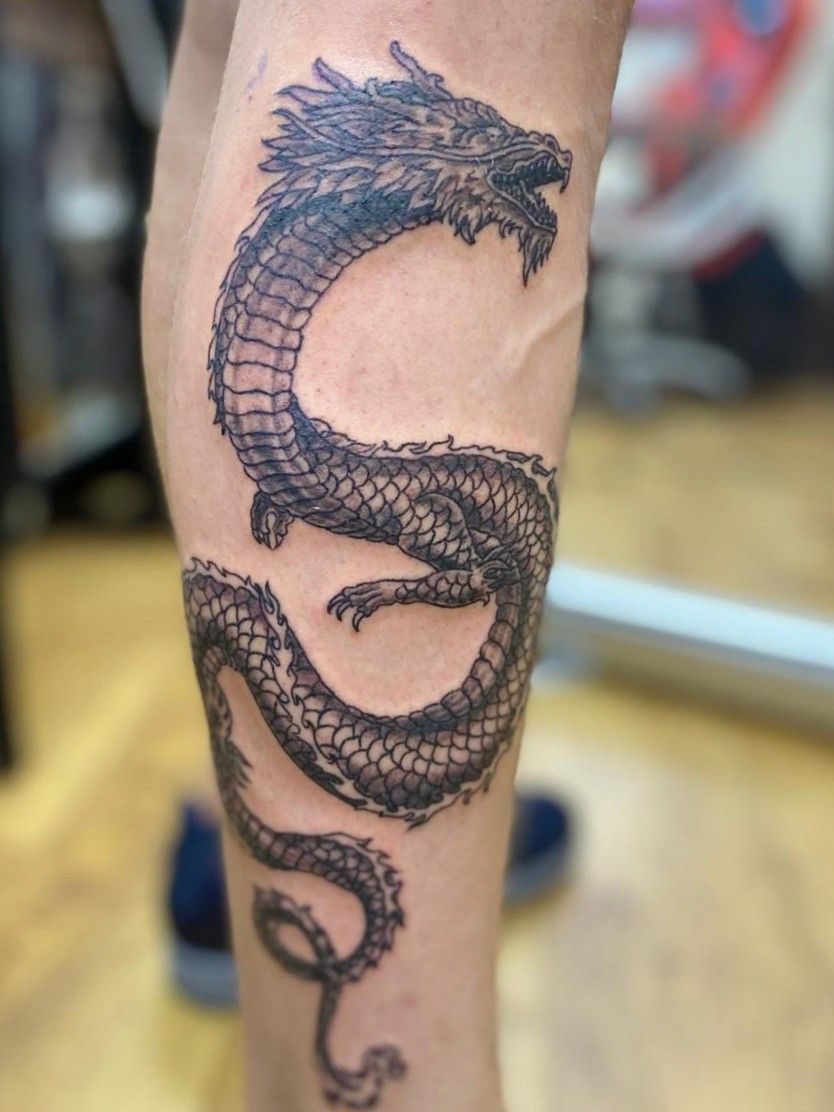 dragon tattoo wrapped around forearm