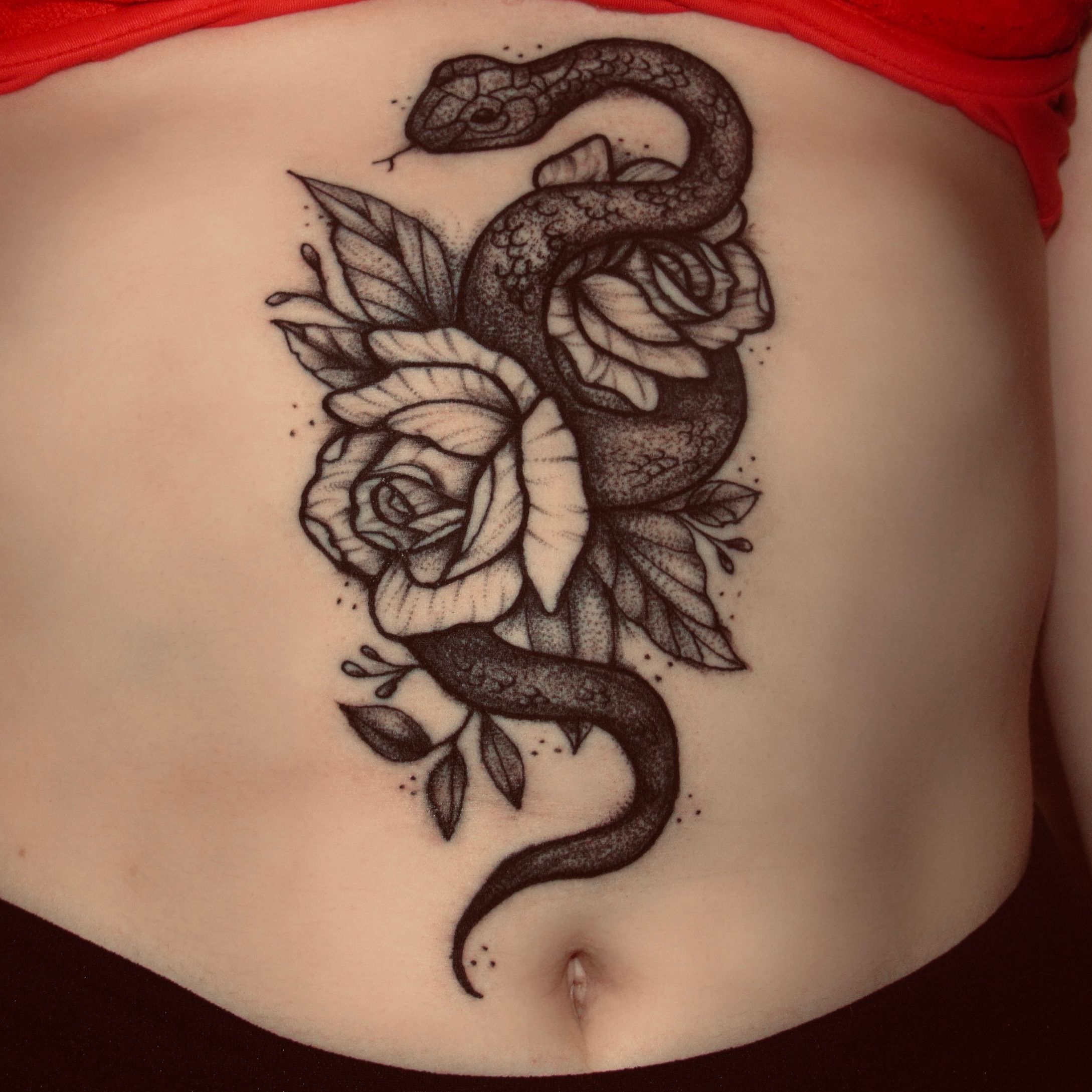 Rose tattoos on the stomach and hip hiding a skar