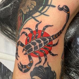 Get inked by the talented Andrea Furci with this fierce traditional scorpion design on your knee. Stand out with this bold and classic tattoo!
