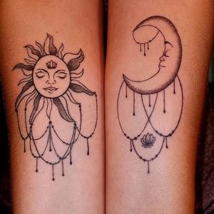 Sun and moon bohemian tattoos on forearms. 