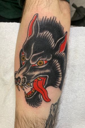 Get inked with a classic traditional style dog tattoo on your lower leg by the talented artist Andrea Furci. Show off your love for your furry friend in style.