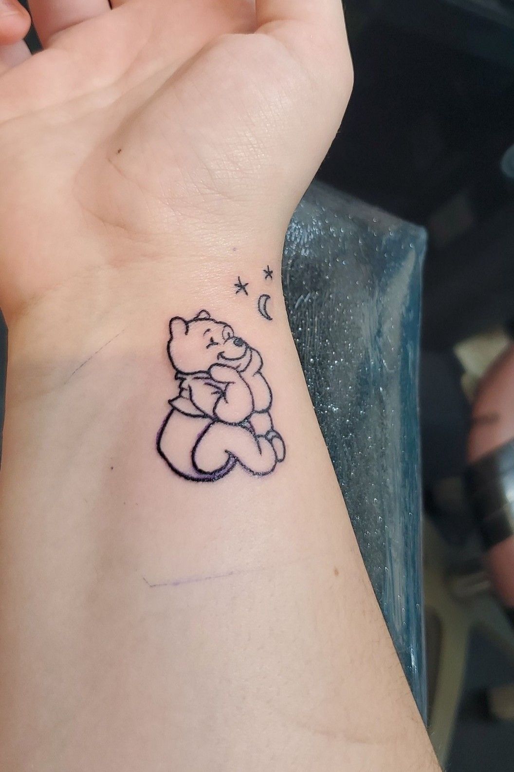 Fine line Pooh Bear tattoo on the inner arm