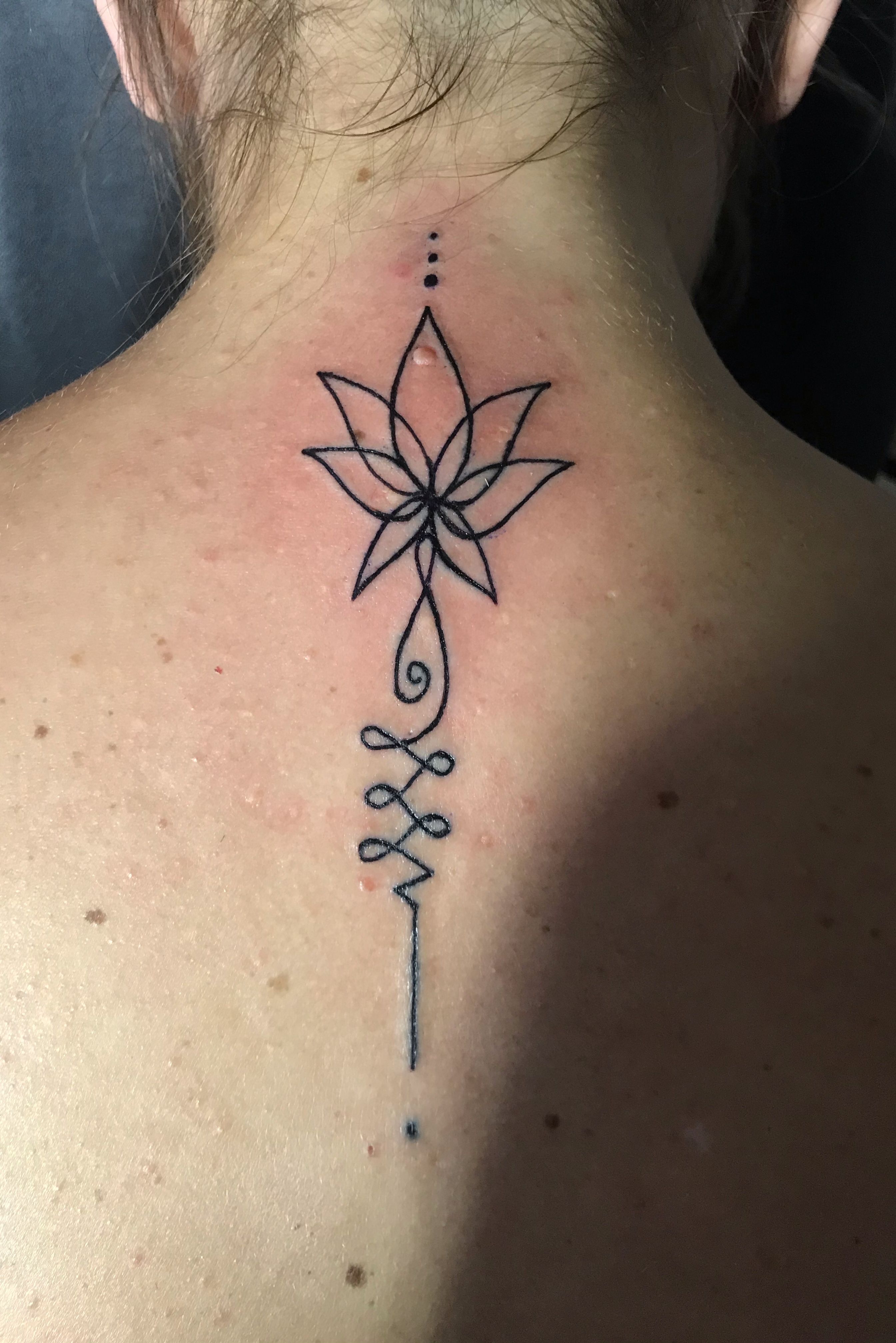 Fine line lotus flower tattoo on the upper back. | Lotus flower tattoo,  Flower tattoo, Nature tattoos