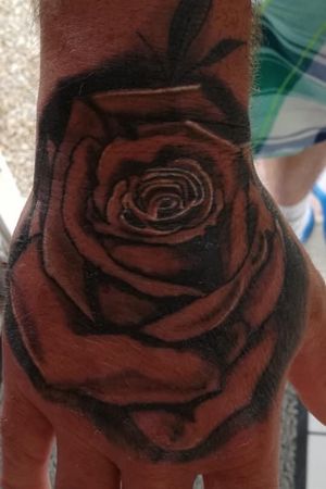 Realistic rose on hand healed no retouch no filter