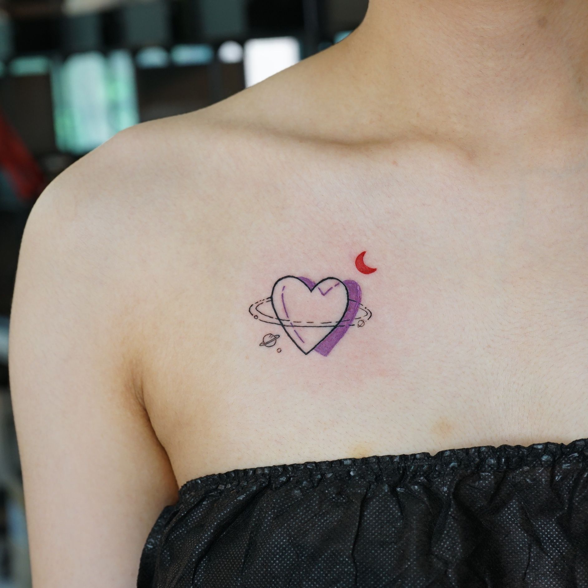 Watercolor style heart tattoo on the wrist.