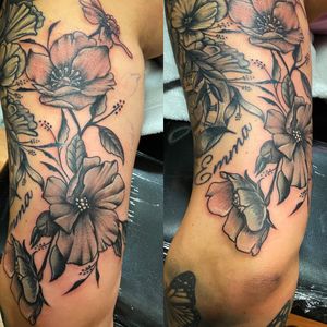Black and gray flowers done on back of upper arm triceps area