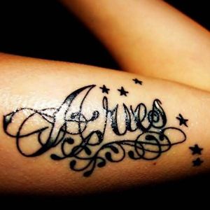Aries cursive tattoo surrounded by stars #aries #armtattoo #stars