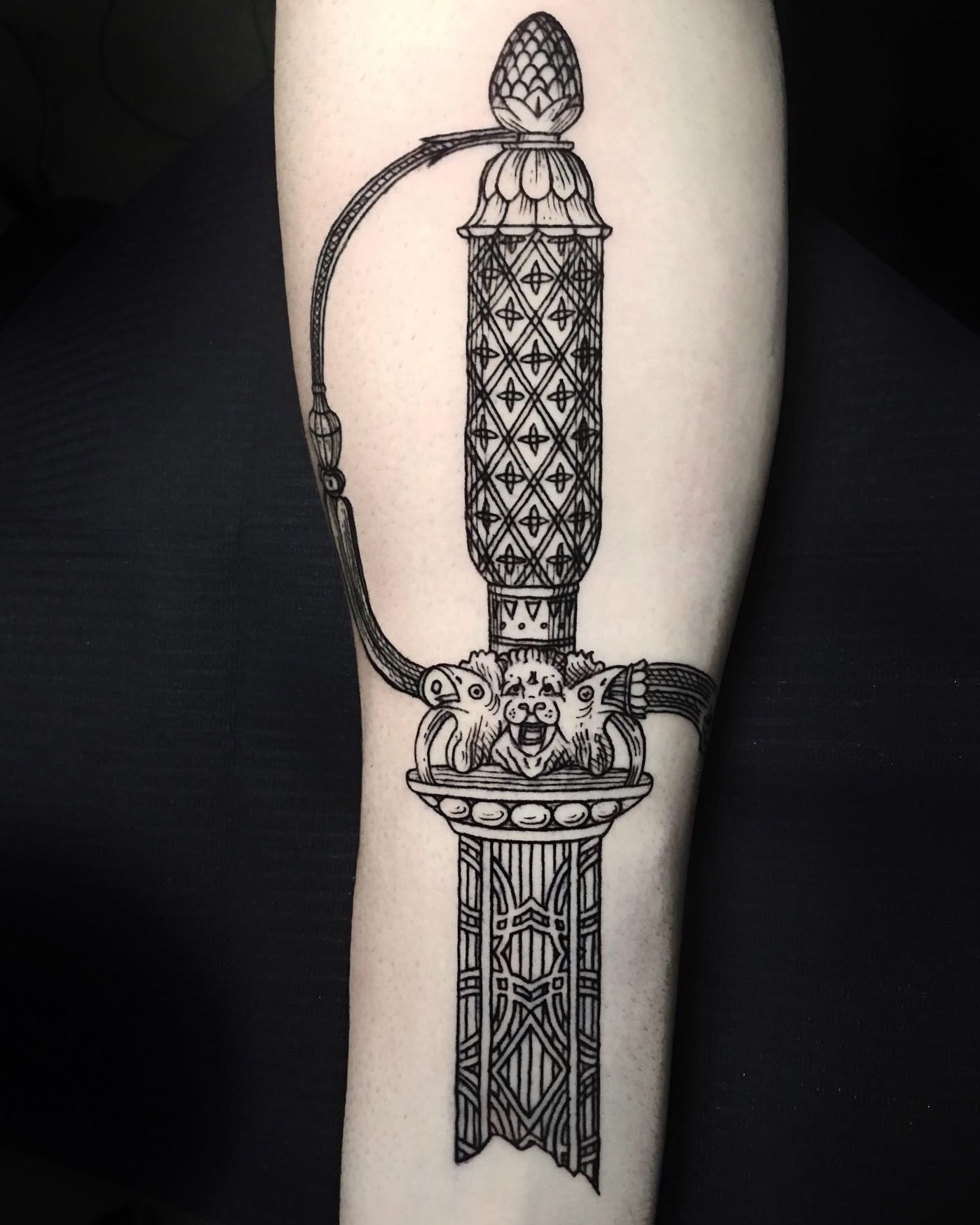 sword tattoo on the forearm of girl