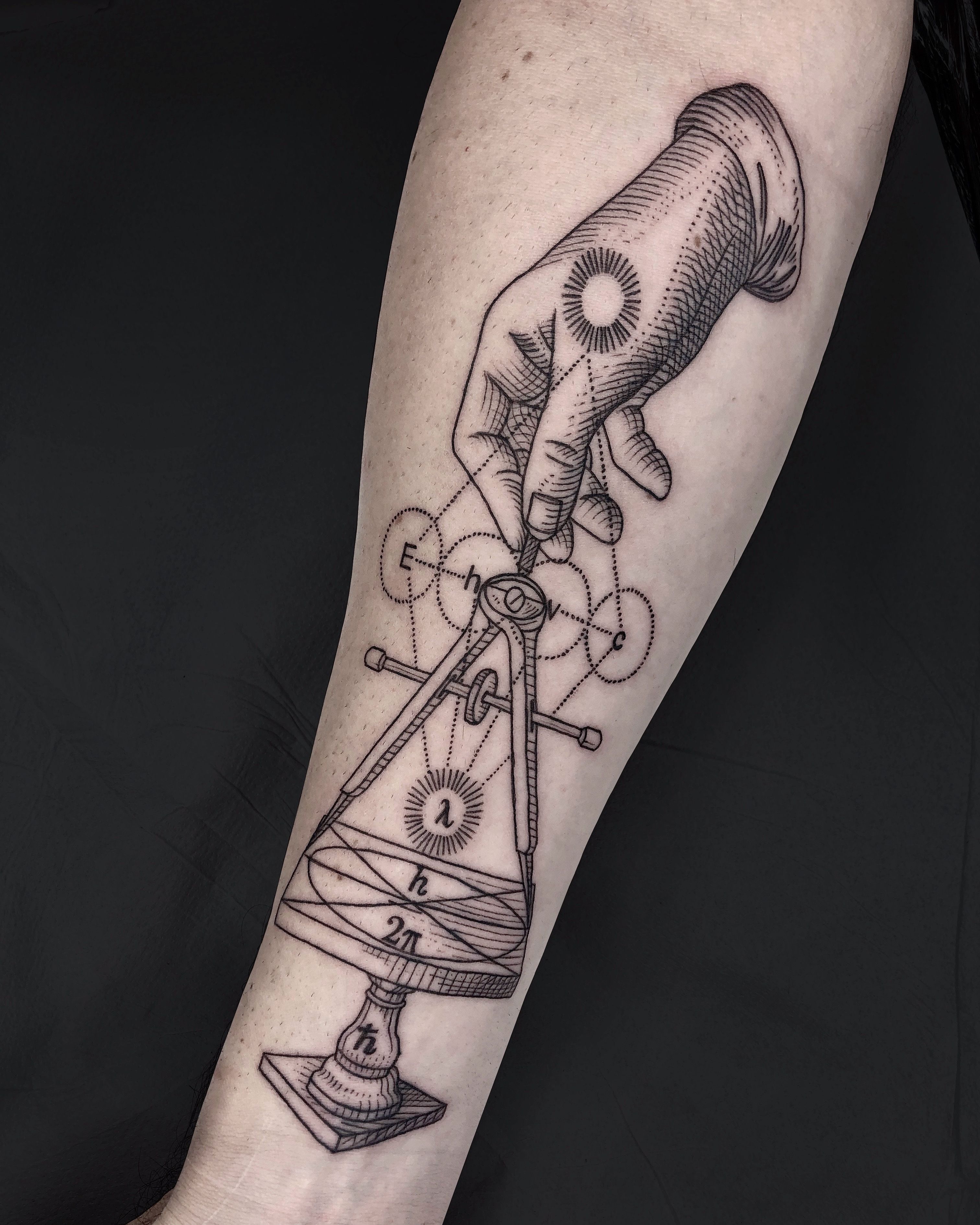 Minimalist compass tattoo on the wrist.