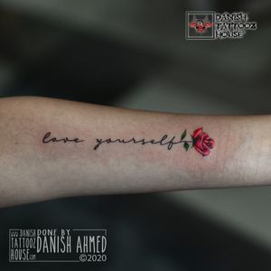 Love Yourself tattoo with a colourful flower.by Danish Ahmed