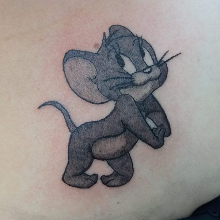 Cartoon style Jerry tattoo located on the inner