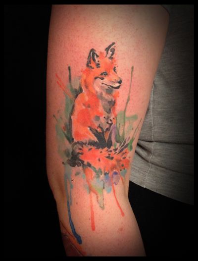 Express your wild spirit with a stunning watercolor fox tattoo by Aygul. The intricate details and vibrant colors will make this piece stand out.