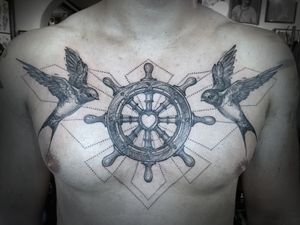Traditional black and gray chest tattoo of a bird sailing, done by Aygul with intricate geometric details.