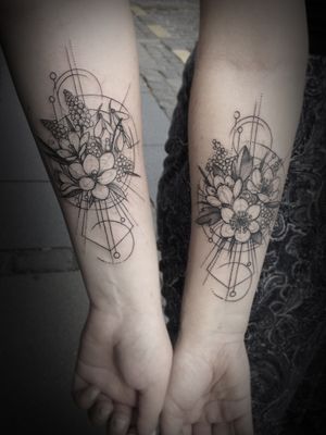 Elegant and intricate geometric design featuring a beautiful flower motif, expertly done by tattoo artist Aygul on your forearm.