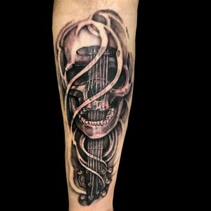 Rock and roll guitar skull tattoo 