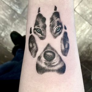 “Wolf in a paw” tattoo