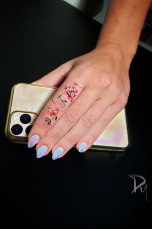 Lovely finger color flower tattoo by Montreal tattoo artist Dylan C