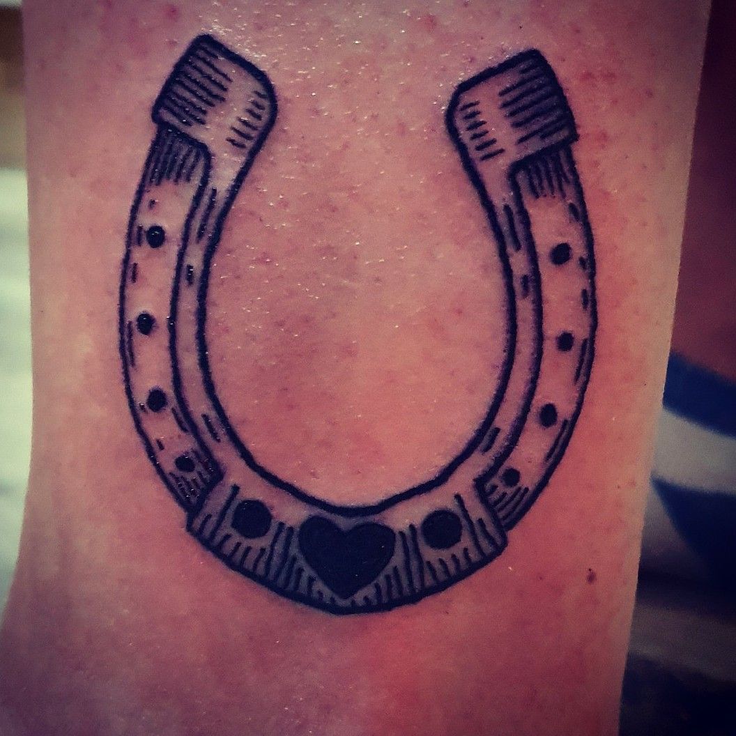 Minimalistic style horseshoe tattoo located on the
