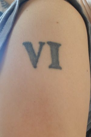 First tattoo done when I was 18. VI (6) I was born the 6 mouth of the year 6 has always been my favorite number and after seeing bleach I always wanted to get it tattooed on me so I did.... im the sixth.