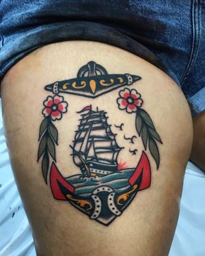Featuring elements of the ocean - water, bird, flower, anchor, and ship - in a traditional style by Felipe Reinoso. A timeless and classic design for your upper leg.
