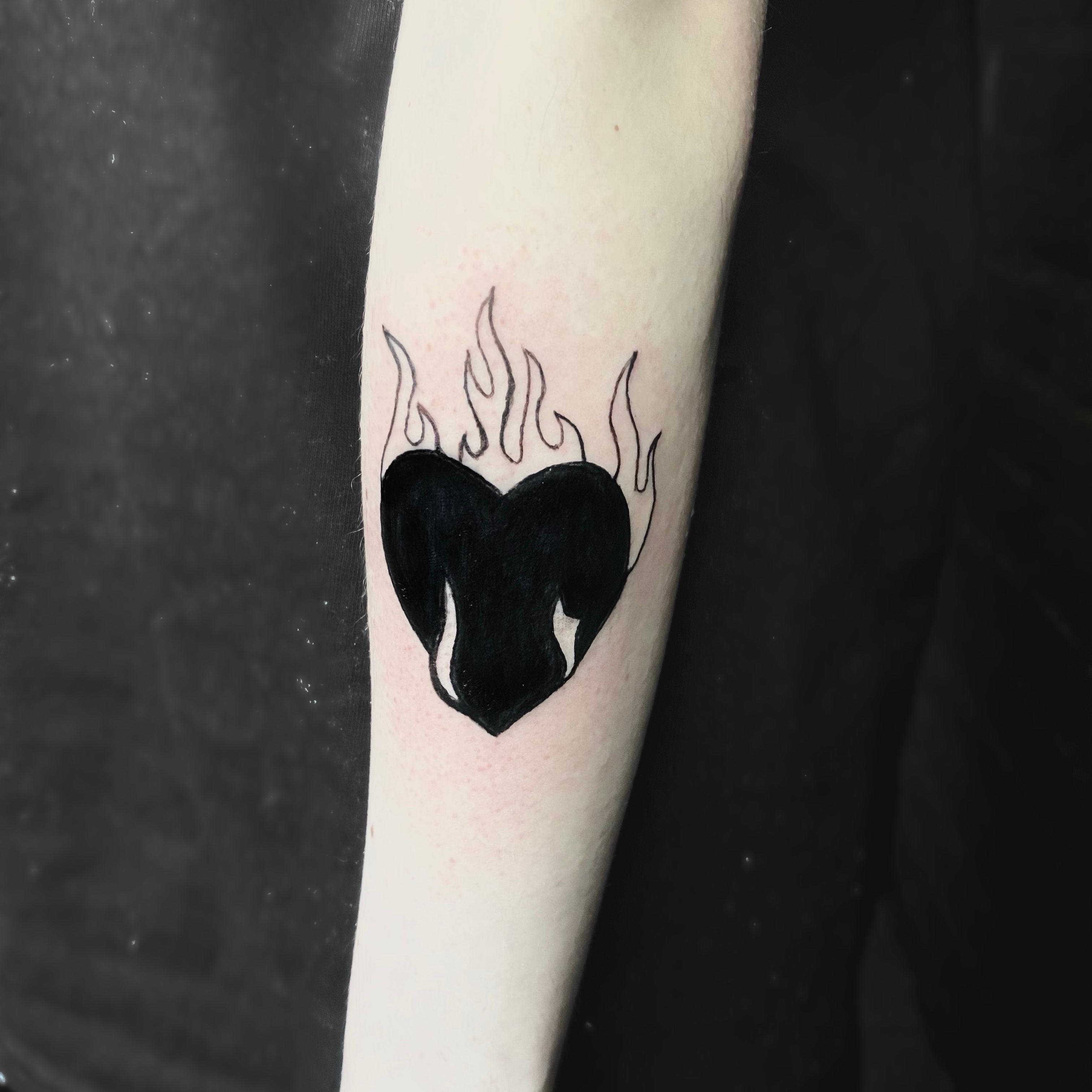 Black Ink Fire And Flame Tattoo On Man Left Half Sleeve