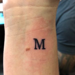 Small “M” wrist tattoo (Artist: Izic Woodall at Holy Grail Tattoos in Lakeland, Florida) 
