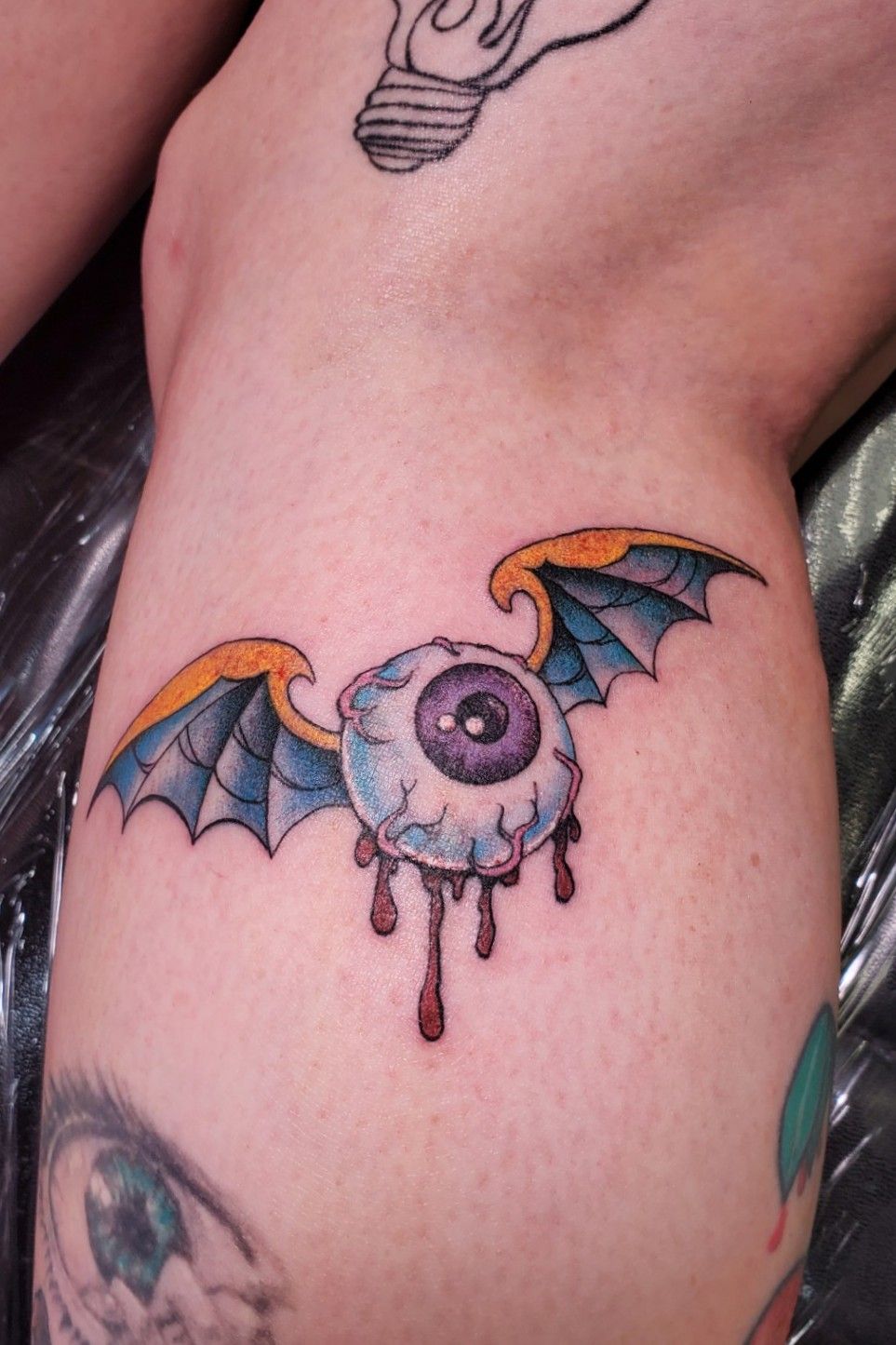 Triangle eye wings tattoo