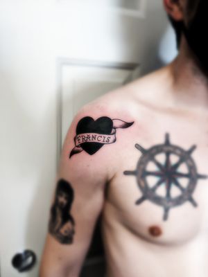 Black heart tattoo with banner and name