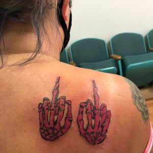 Hot pink skeleton hands tattooed by Mylie Harper 