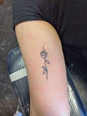 Line tattoo of a rose