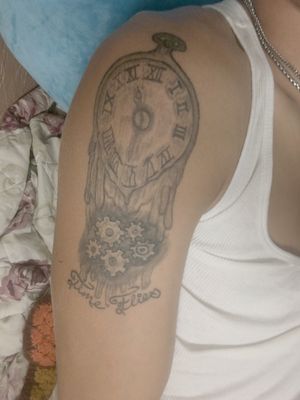Great melting clock tattoo with the hands pointed at the time I was born 11:32 and the caption time flies is a lil different approach but still so true
