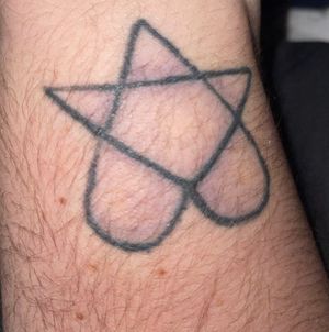 Tattoo of a heartagram on my right wristDone in my house