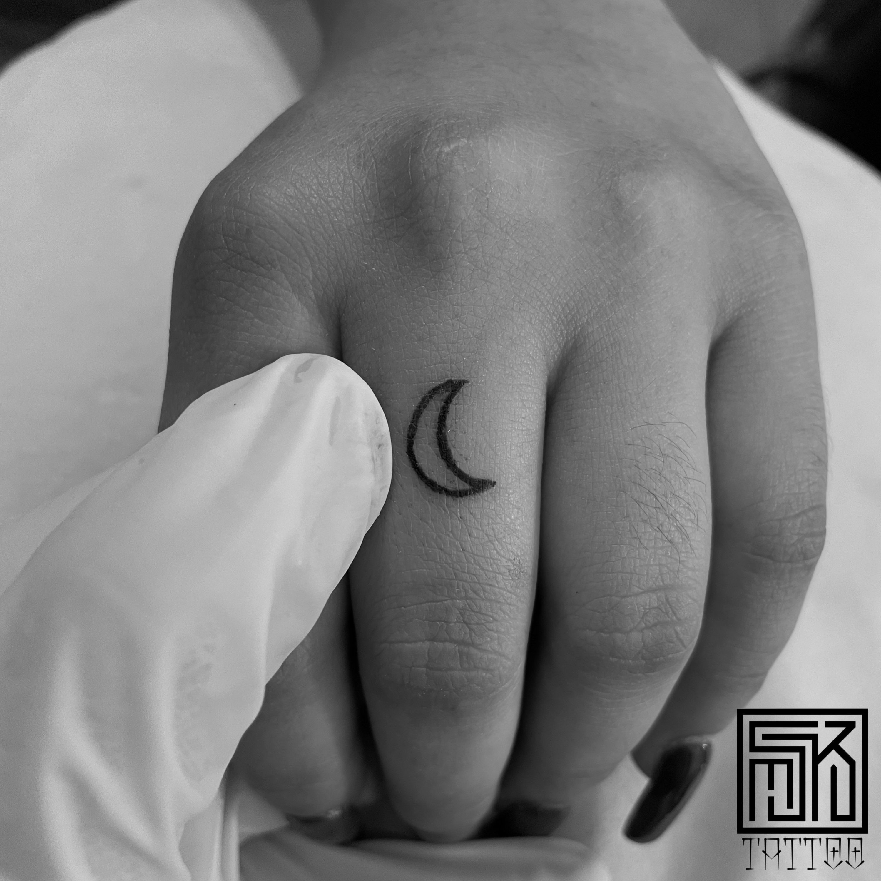 crescent moon tattoo finger
