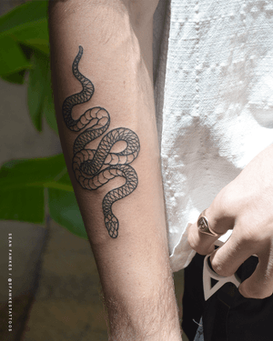 An intricate blackwork snake design on the forearm by Gareth Doye. Bring a touch of mystique to your ink collection.