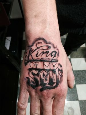 Text tattoo on hand 