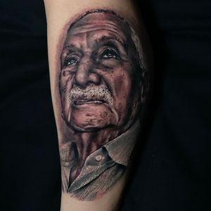Impressive black and gray illustrative tattoo of a man on the forearm by Marcel Oliveira