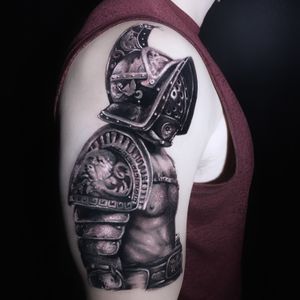 Experience the power of blackwork and realism in this illustrative warrior helmet tattoo by Marcel Oliveira.