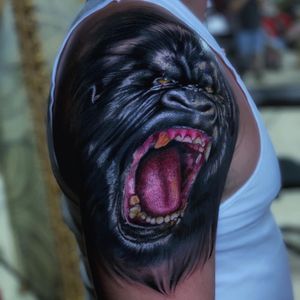 Impressive upper arm tattoo by Marcel Oliveira featuring a detailed and lifelike gorilla in blackwork style