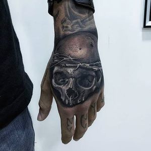 Experience the haunting beauty of Marcel Oliveira's black and gray illustrative design on your hand. Perfect for those craving edgy realism.