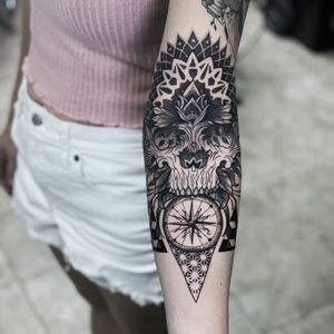 A stunning blackwork and dotwork tattoo featuring a skull, compass, and intricate geometric patterns by Marcel Oliveira.