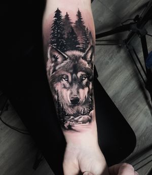 Black and gray illustrative tattoo by Marcel Oliveira featuring a stunningly detailed wolf and tree design. Perfect for nature lovers!