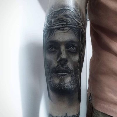 Detailed black and gray forearm tattoo by Marcel Oliveira, showcasing Jesus and thorns in a stunning illustrative style.