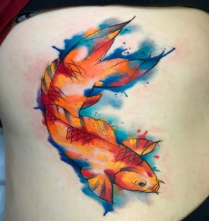 Colorful and whimsical fish illustration tattoo on ribs done by skilled artist Marcel Oliveira, combining watercolor style with illustrative techniques.