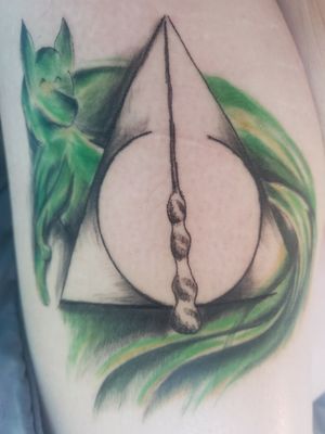 Deathly hallows symbol plus my patronus which is a fox glowing in green to represent slytherin house 😏😊😊 done by Cassidy Blessing Tattoos 