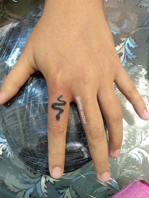 Little snake finger tattoo