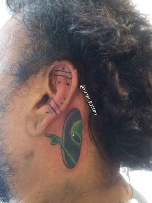 Alien and ear tattoos