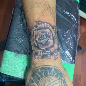 Rose tattoo with year by Daniel Castro @sixxillustrated 