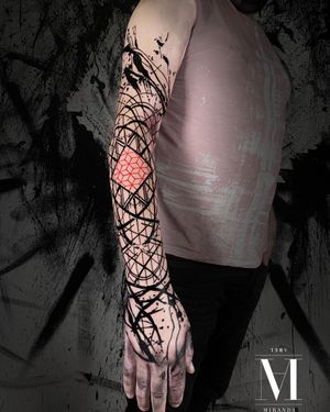 Full sleeve tattoo combining abstract and geometric style.
