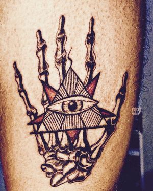 Skeleton hand holds all seeing eye masonic symbol with red pentagram